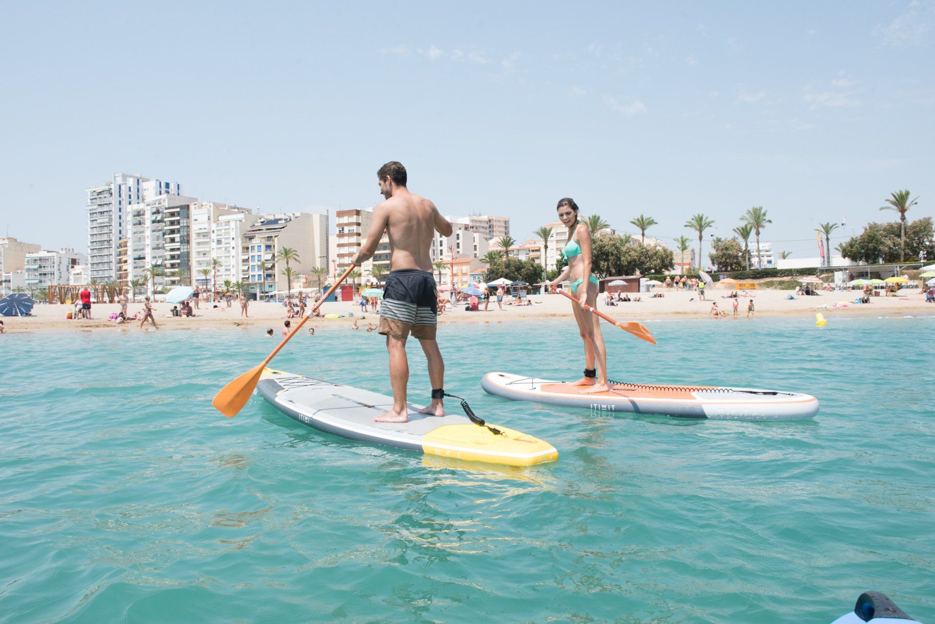 A couple paddle boarding at Vinaros beach Costa Del Azahar near Casa de Olivos