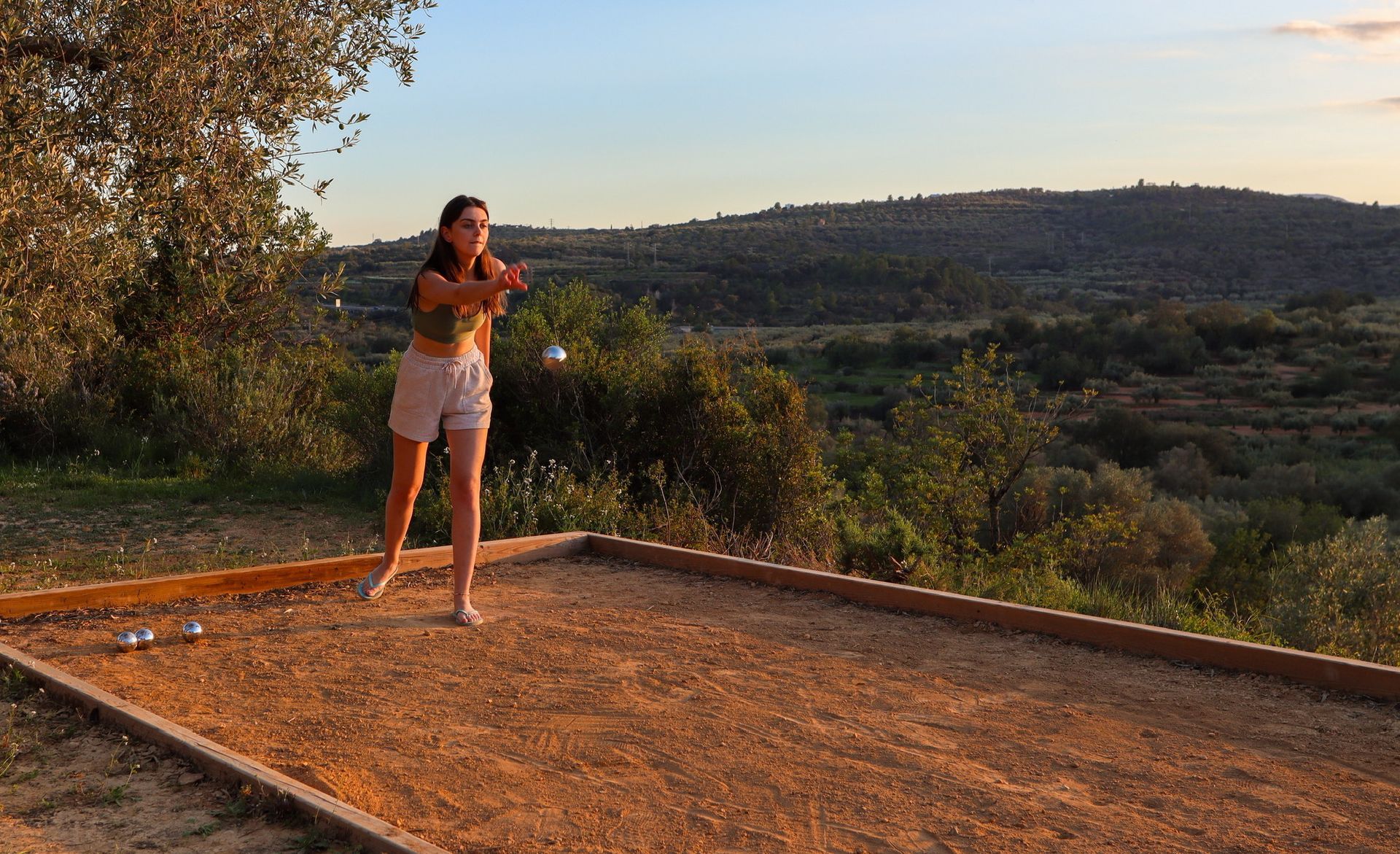 Girl playing petanca at Casa de Olivos near Traiguera