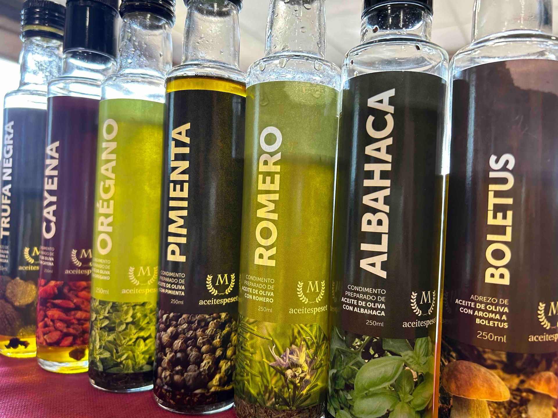 Bottles of Traiguera Olive oils  flavoured with herbs 