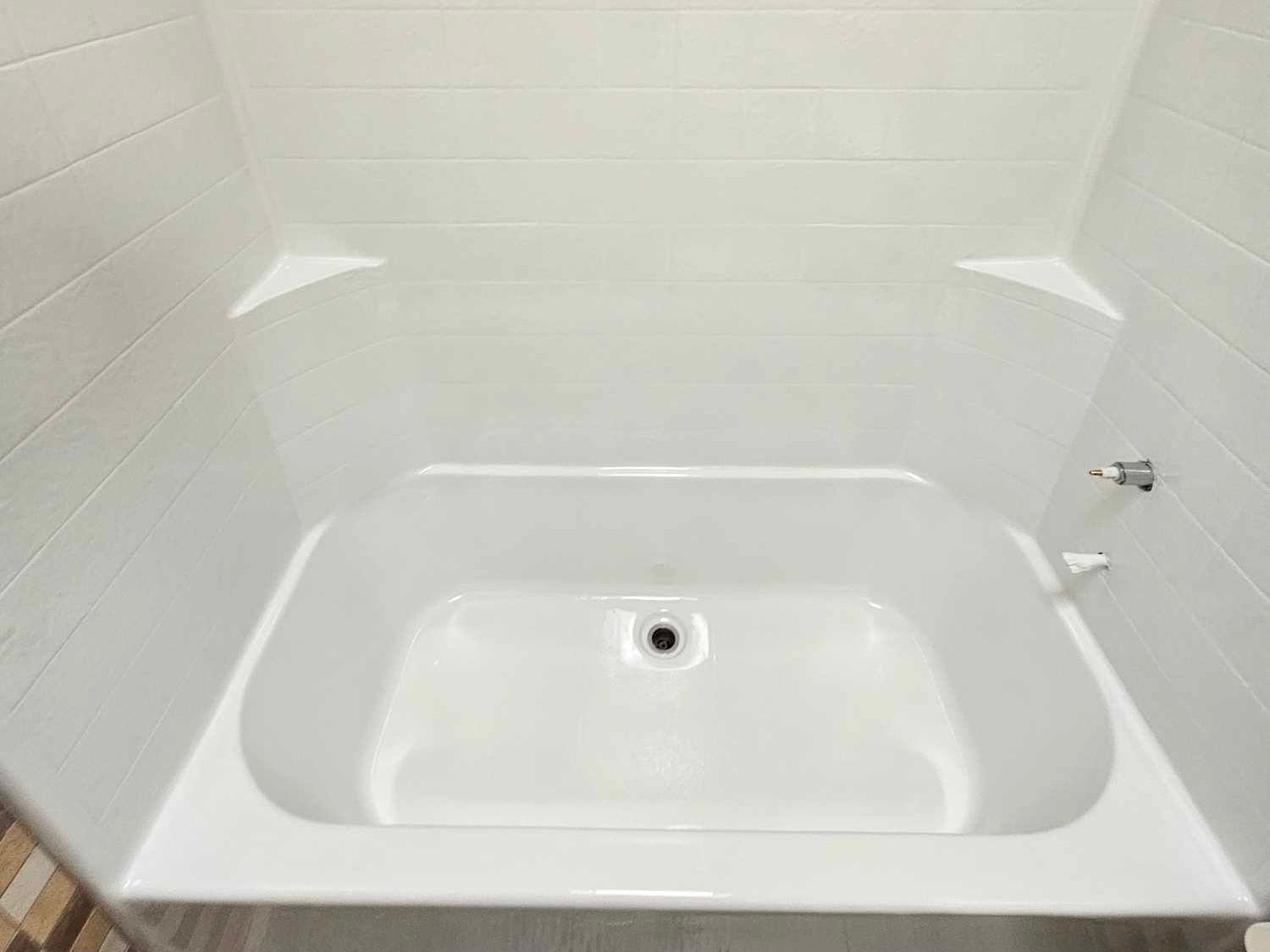 Image of a newly refinished bathtub. You can see a bathtub with a white tile backslpash in the backgorund.