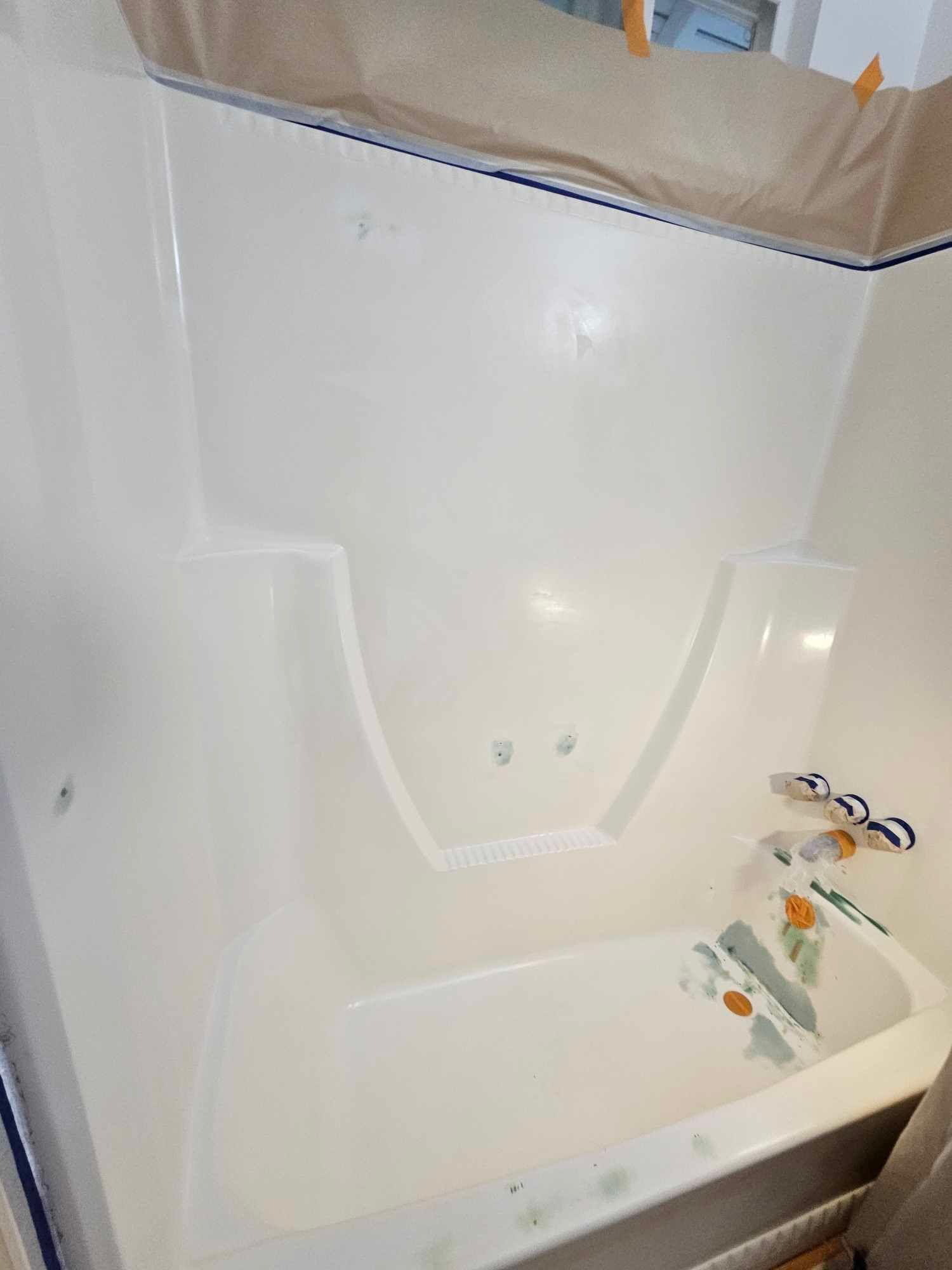 Image of a bathtub that has been prepared for the refinishing service. You can see the tubs scrathes have been coverd.