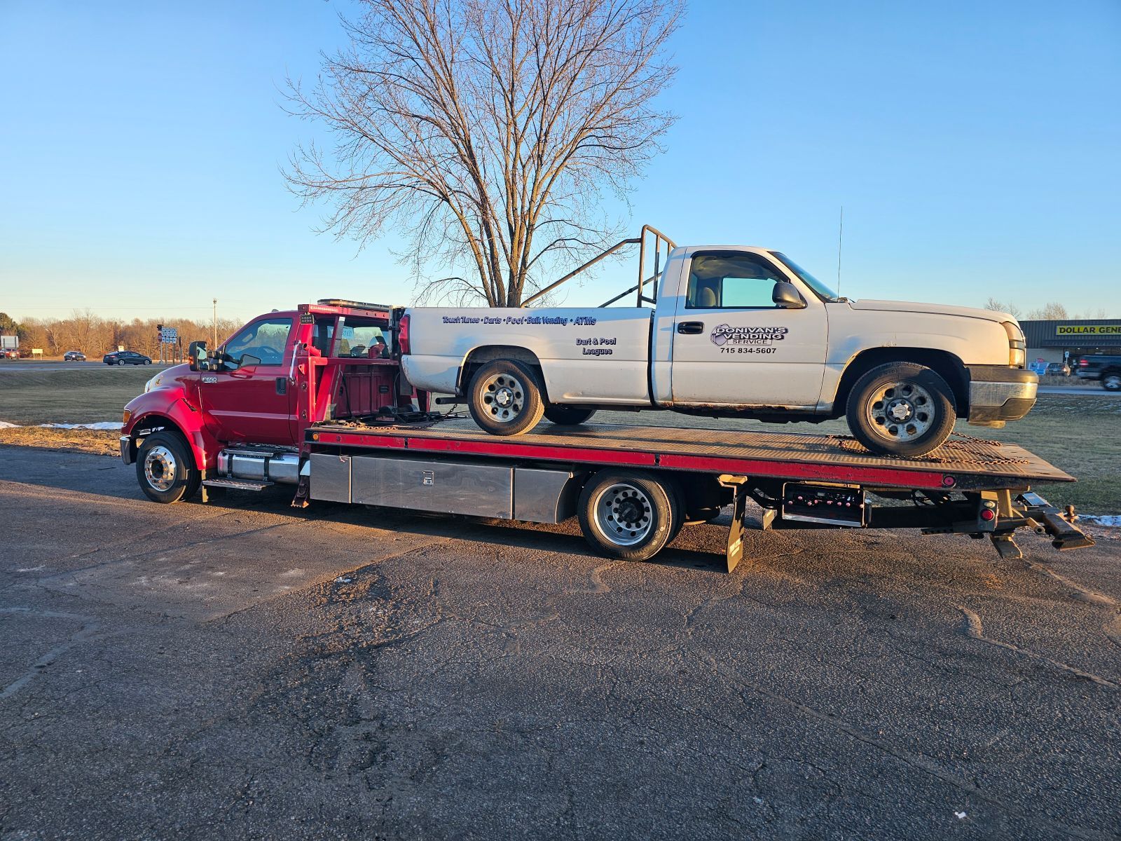 Flatbed Tow Truck Transporting Classic Vehicle In Eau Claire WI | AJM Automotive Services LLC