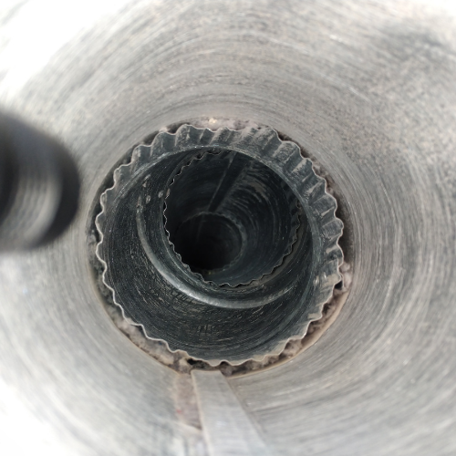 Looking down a dusty, corrugated metal vent.