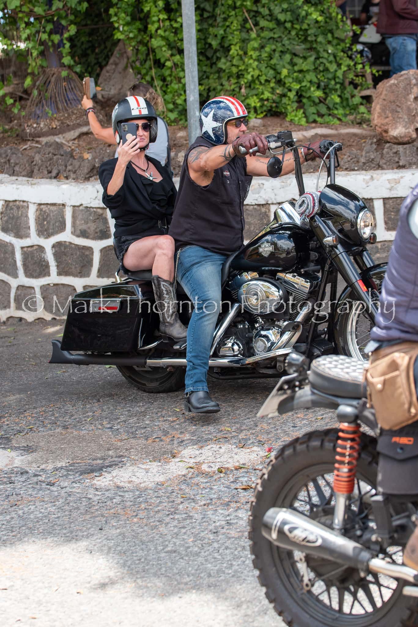 A man and a woman are sitting on a motorcycle.