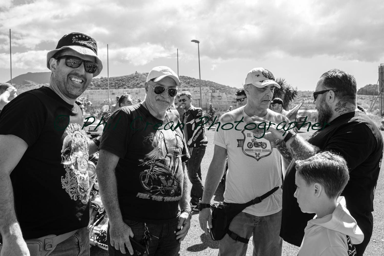 A group of men are standing next to each other in a black and white photo.
