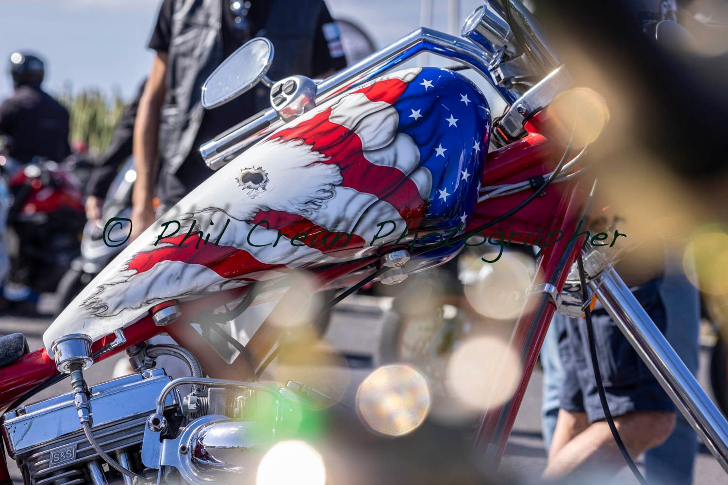 A close up of a motorcycle with an american flag painted on it.
