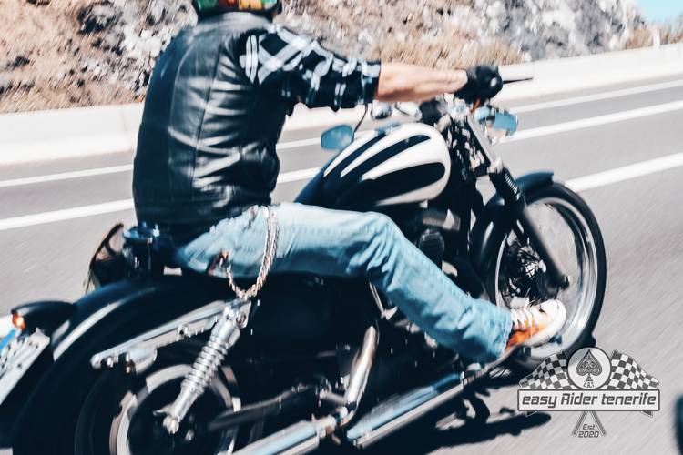 A man is riding a motorcycle on a highway.