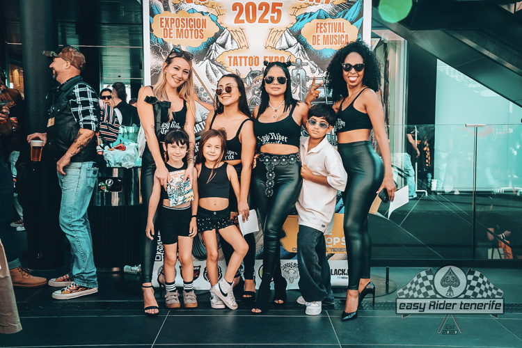 A group of people are posing for a picture in front of a sign that says 2025.