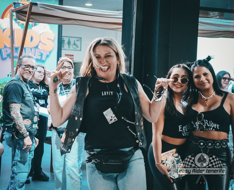 A group of people standing in front of a sign that says kids planet