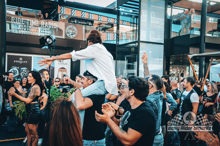 A man is being lifted in the air by a crowd of people at a concert.