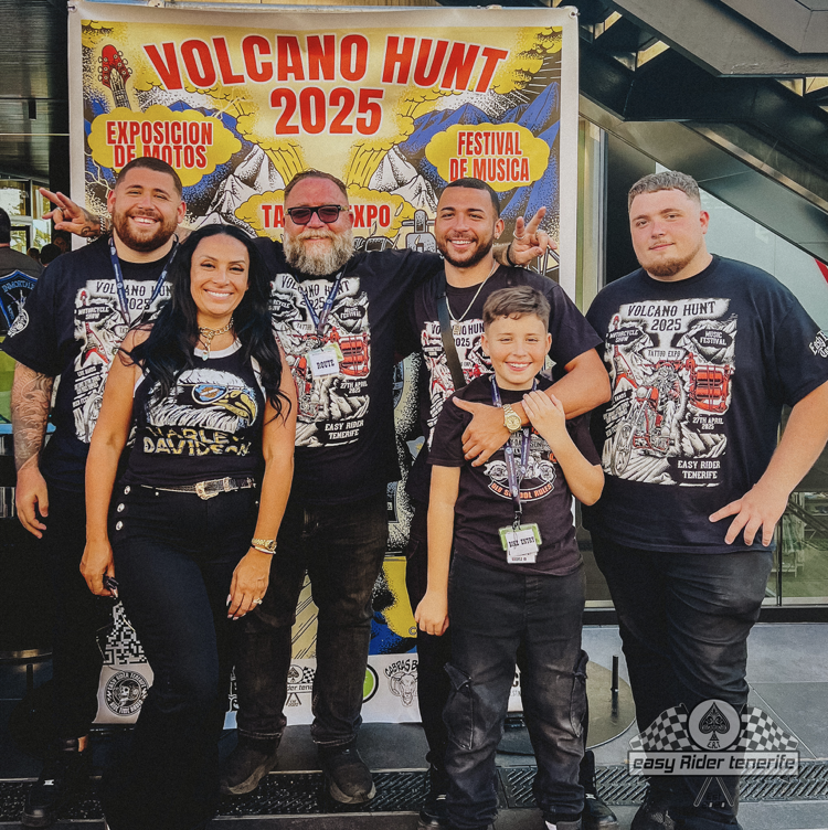 A group of people standing in front of a sign that says volcano hunt 2025