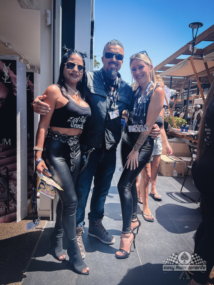 A man and two women are posing for a picture together