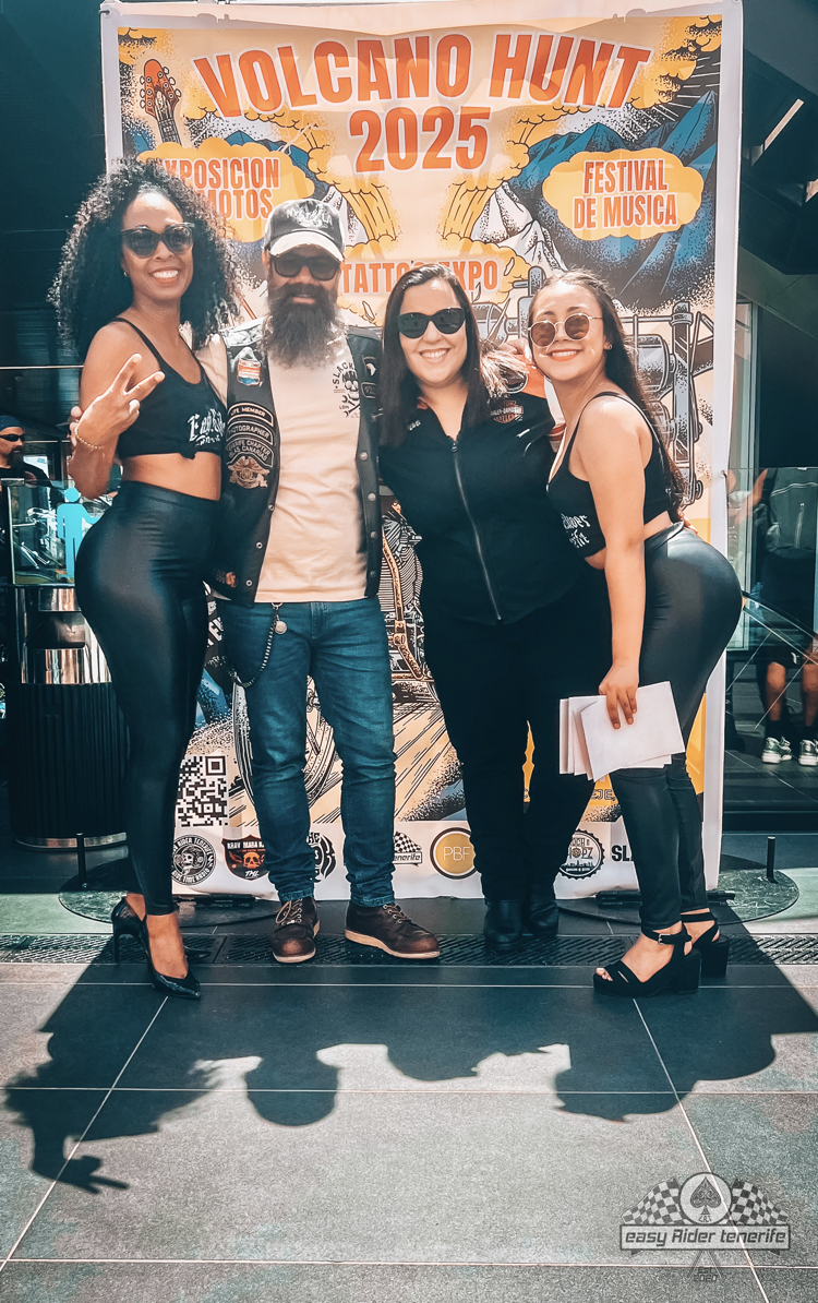 A group of people are posing for a picture in front of a sign that says volcano hunt 2025.