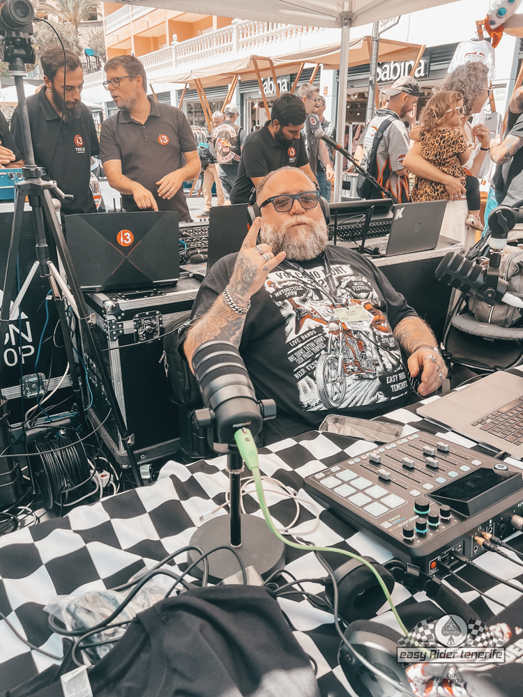 A man with a beard is sitting at a table talking on a cell phone.