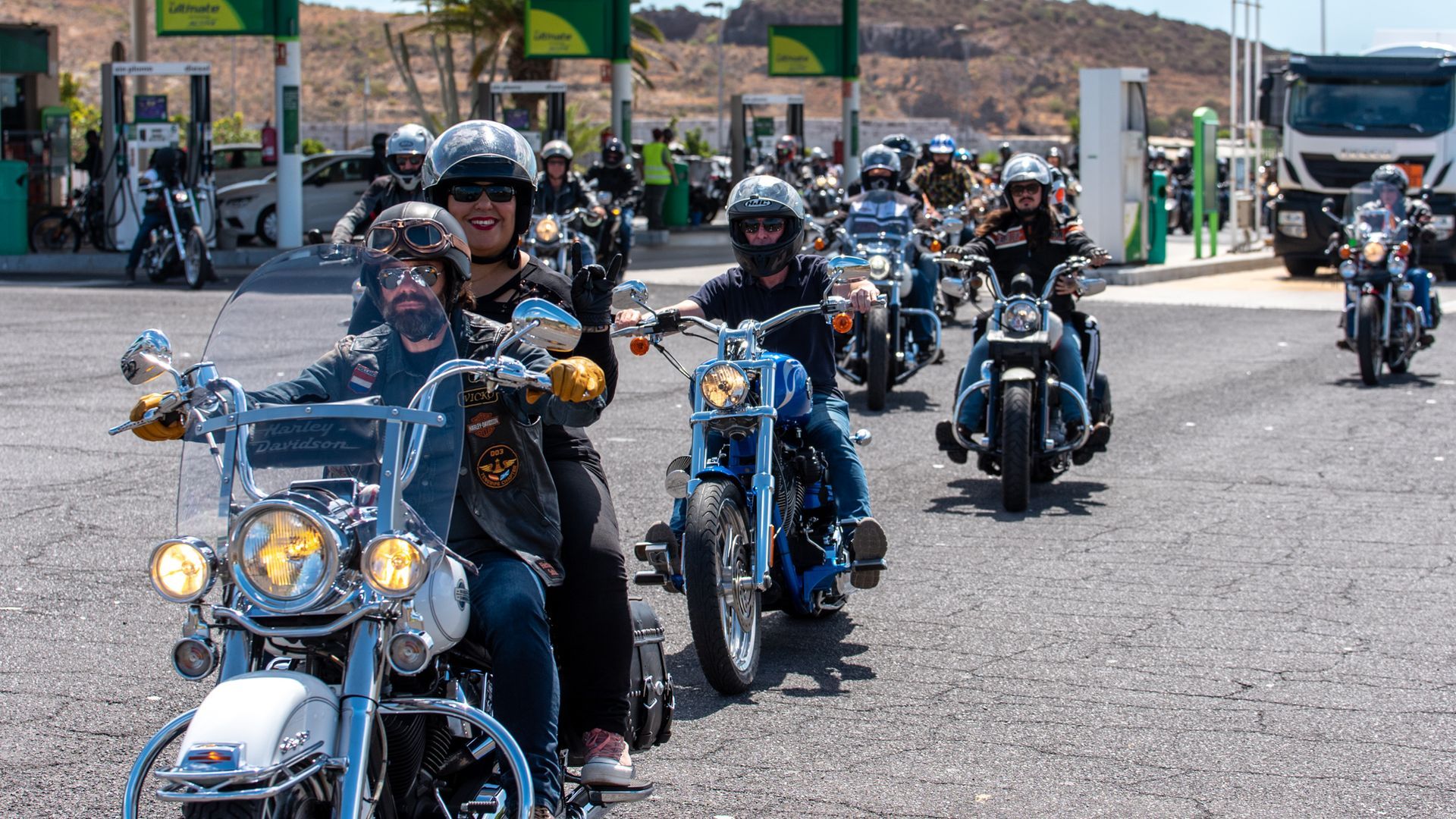 A group of people are riding motorcycles down a road