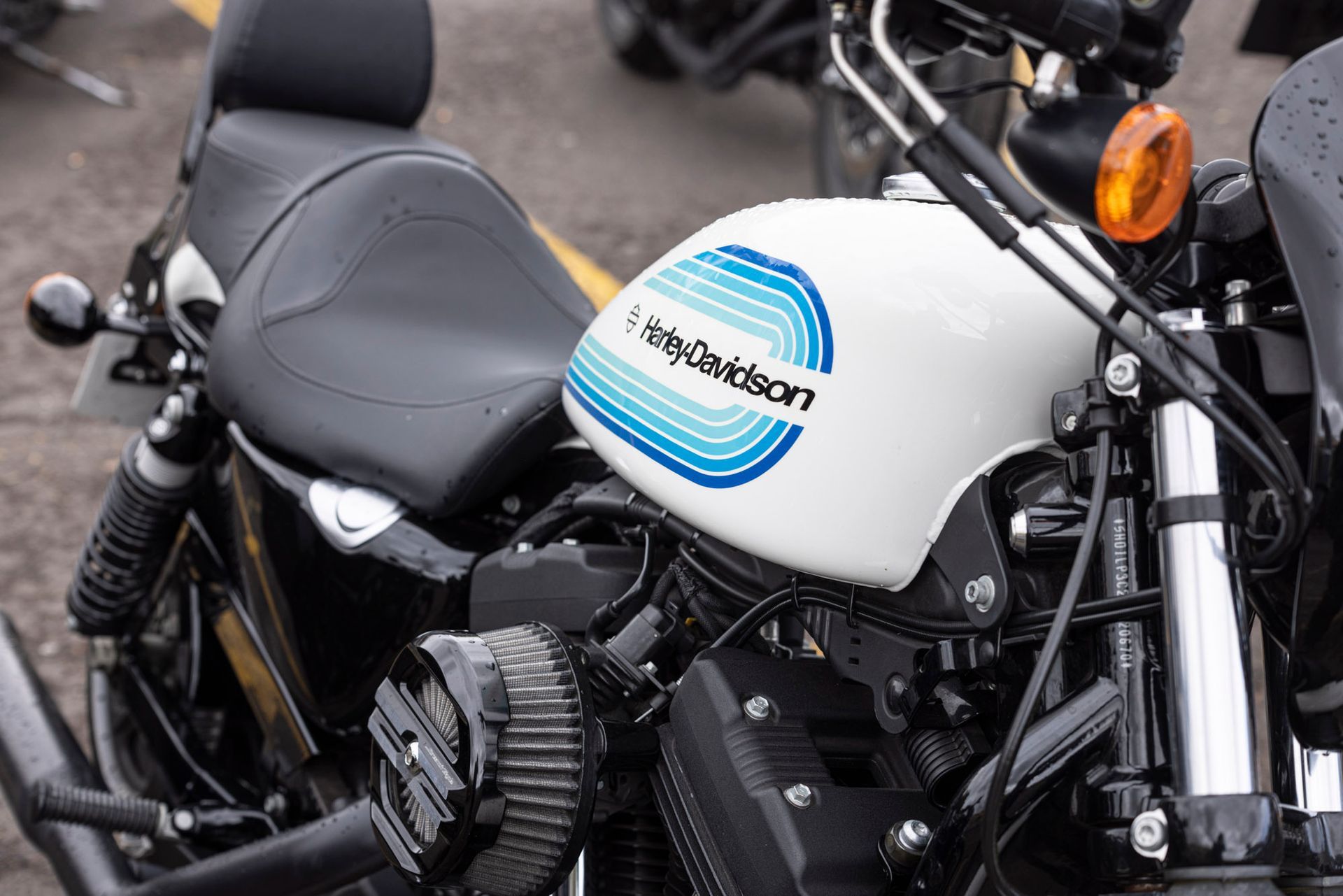 A harley davidson motorcycle is parked in a parking lot.