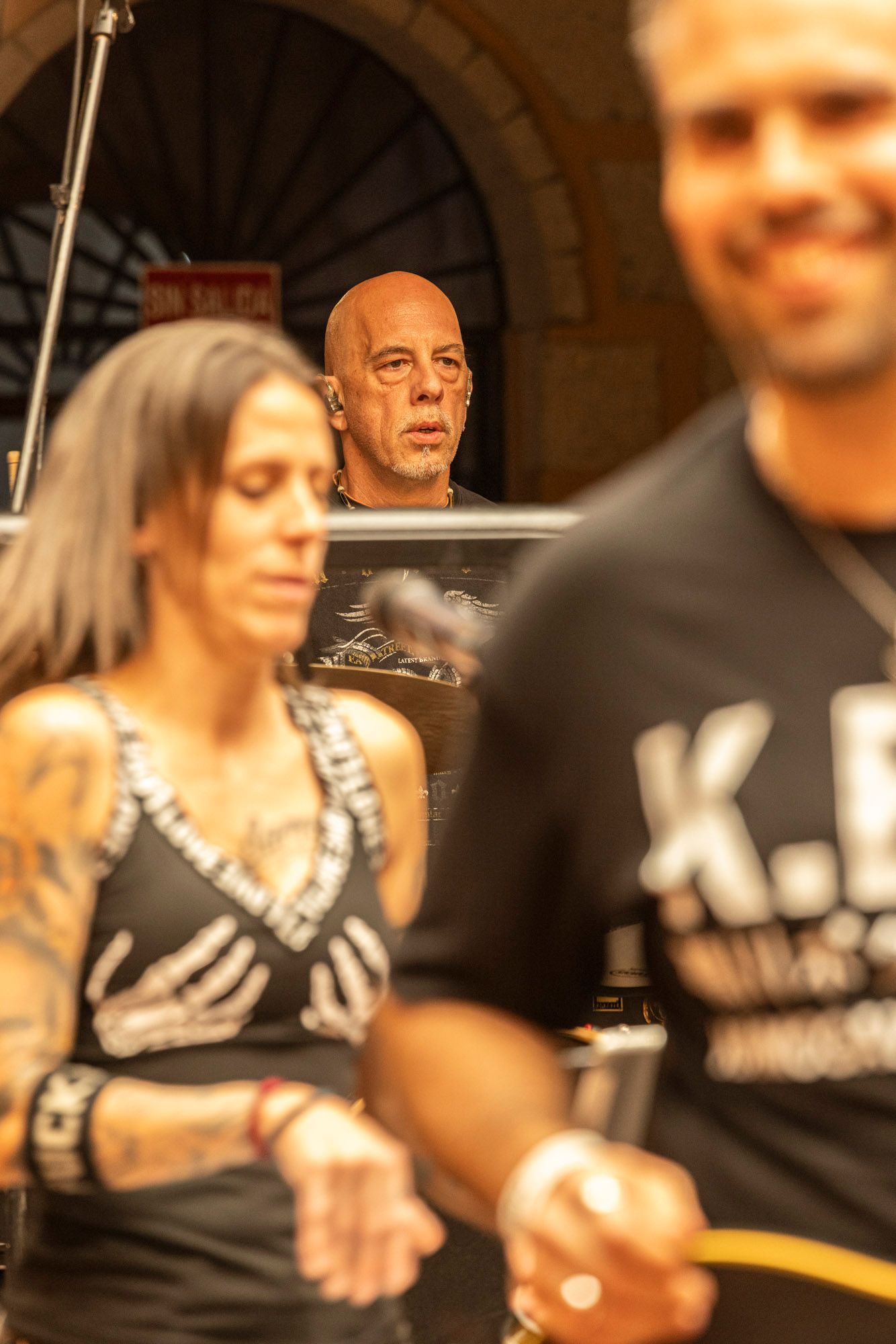 A man and a woman are standing next to each other and the man is wearing a shirt that says k.e.