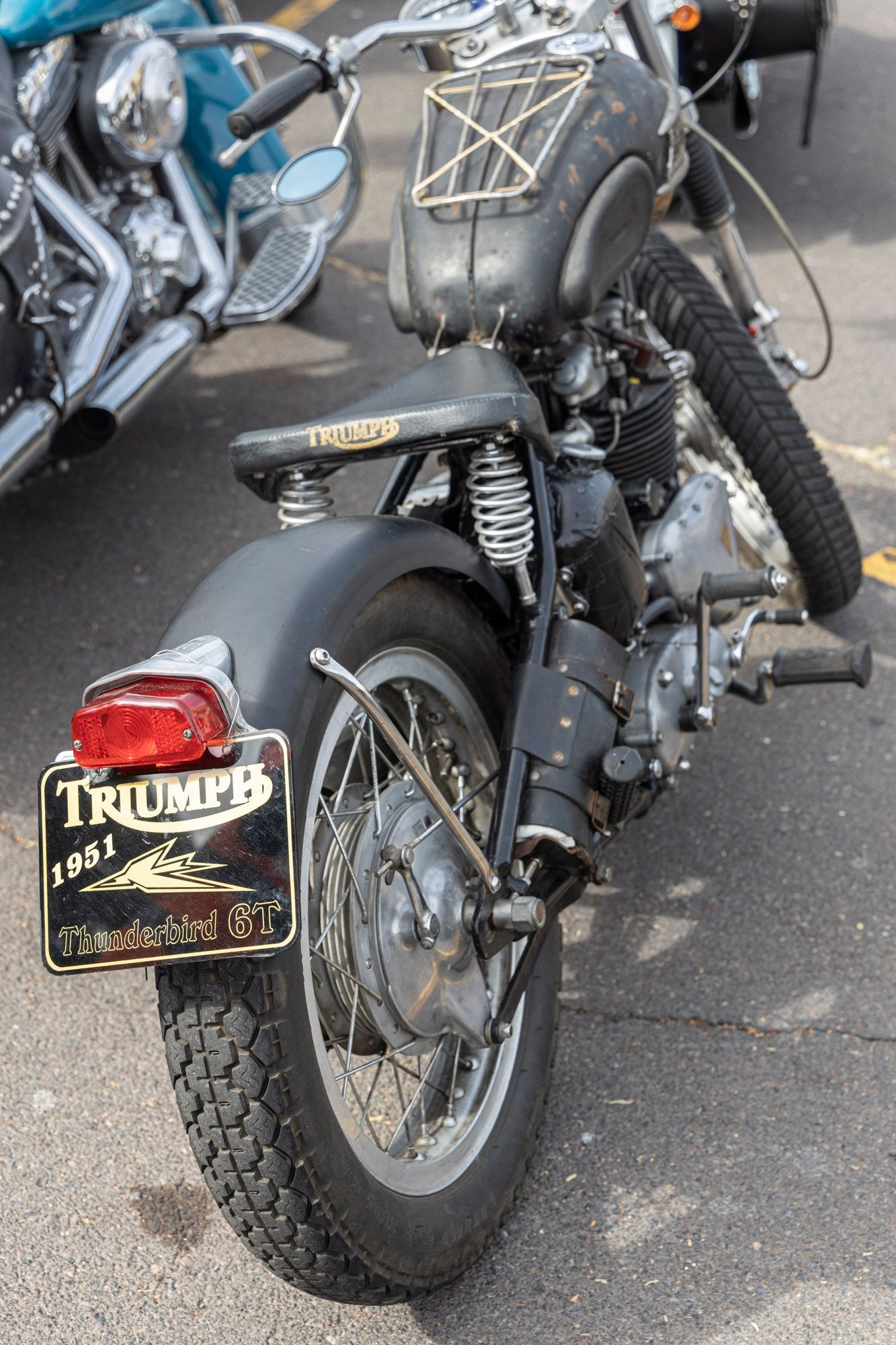 A triumph motorcycle is parked on the side of the road