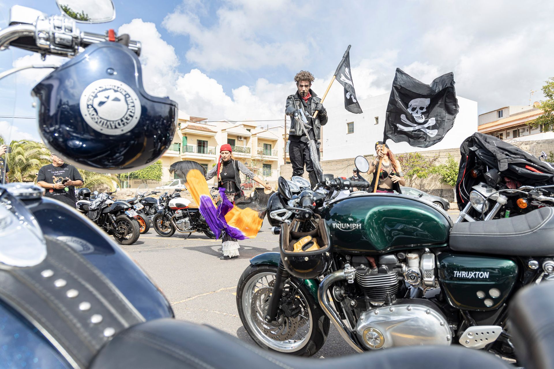 A group of motorcycles are parked in a parking lot.