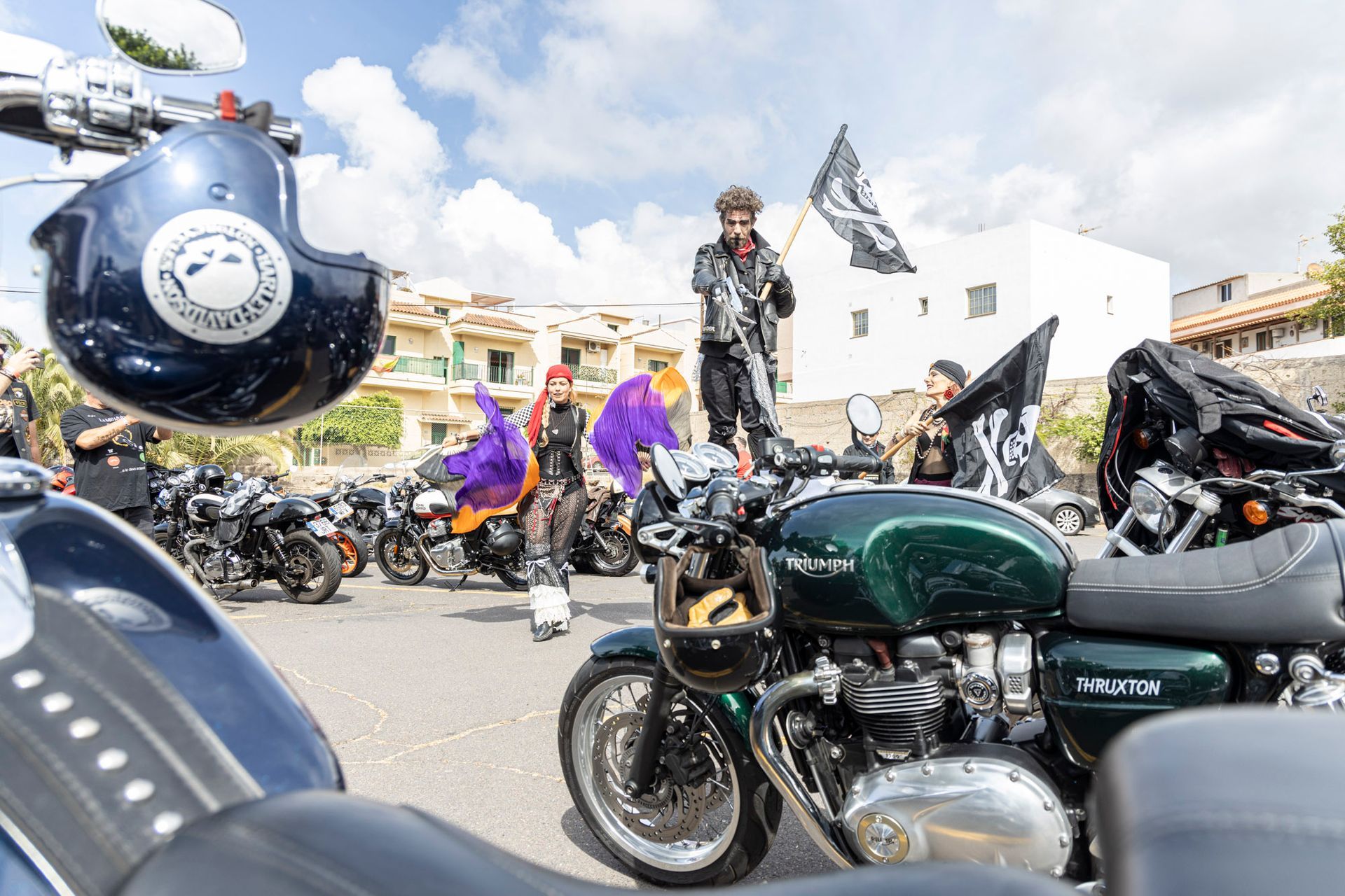 A group of motorcycles are parked on the side of the road.