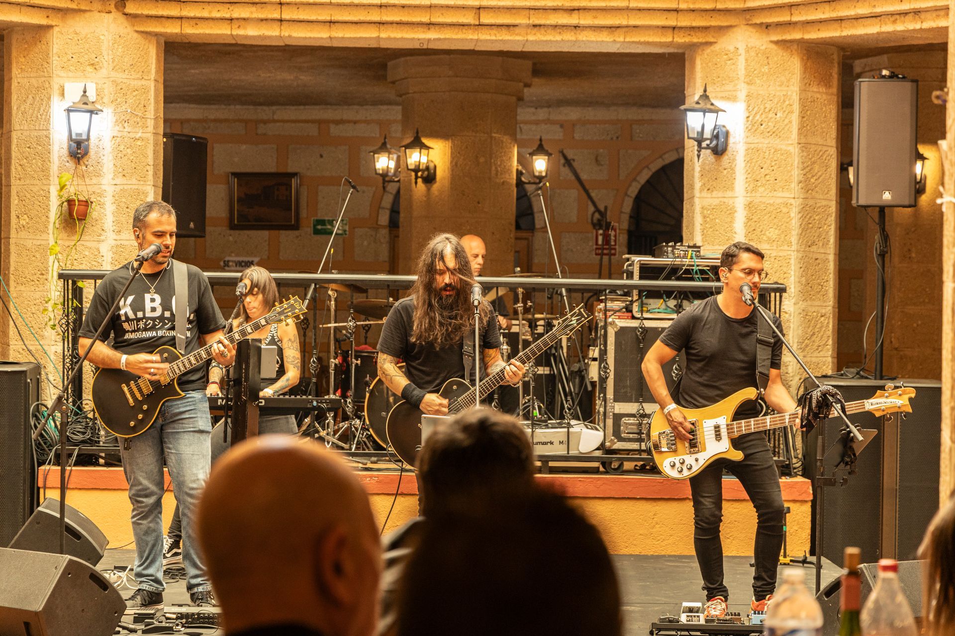 A group of men are playing guitars and singing into microphones on a stage.