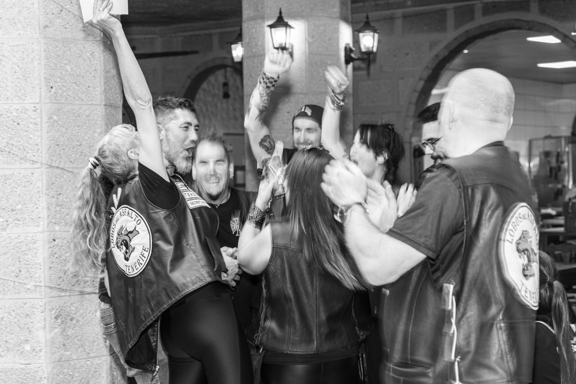 A group of people are standing next to each other in a black and white photo.