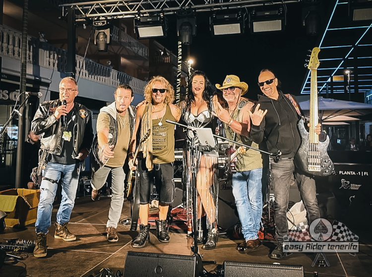 A group of people are posing for a picture on a stage.