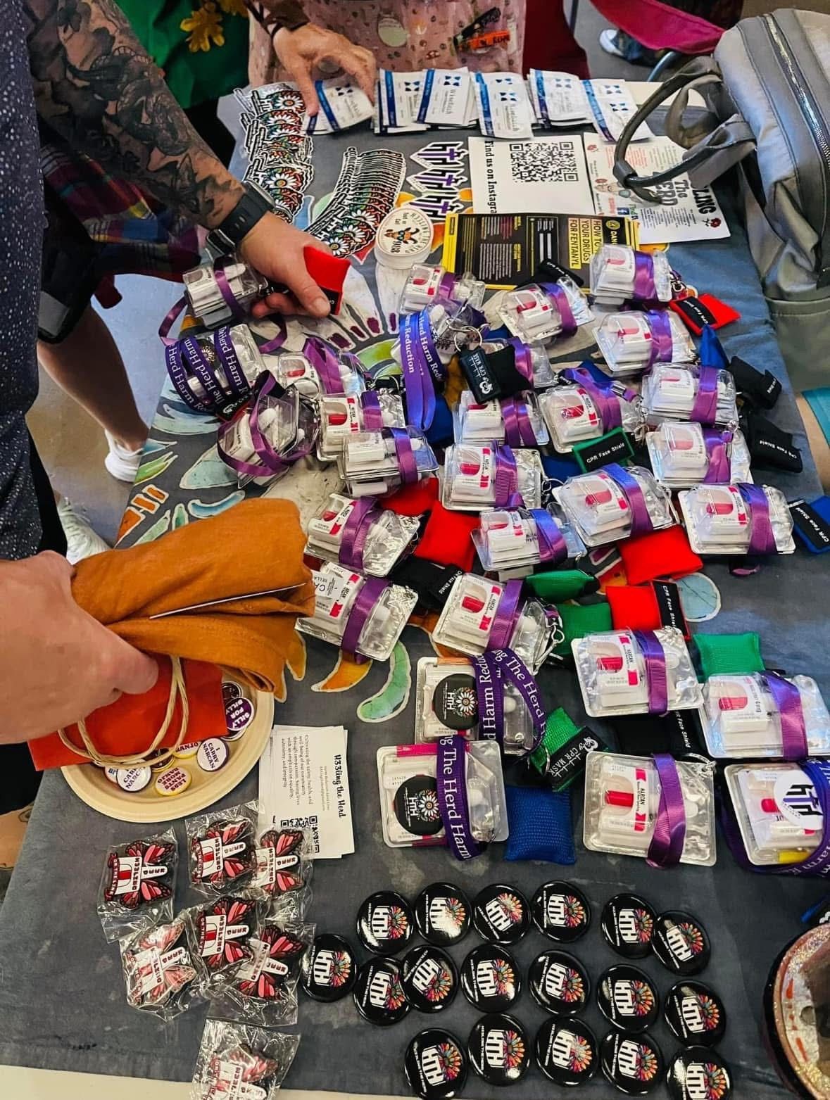 A person is standing at a table with a lot of buttons on it.
