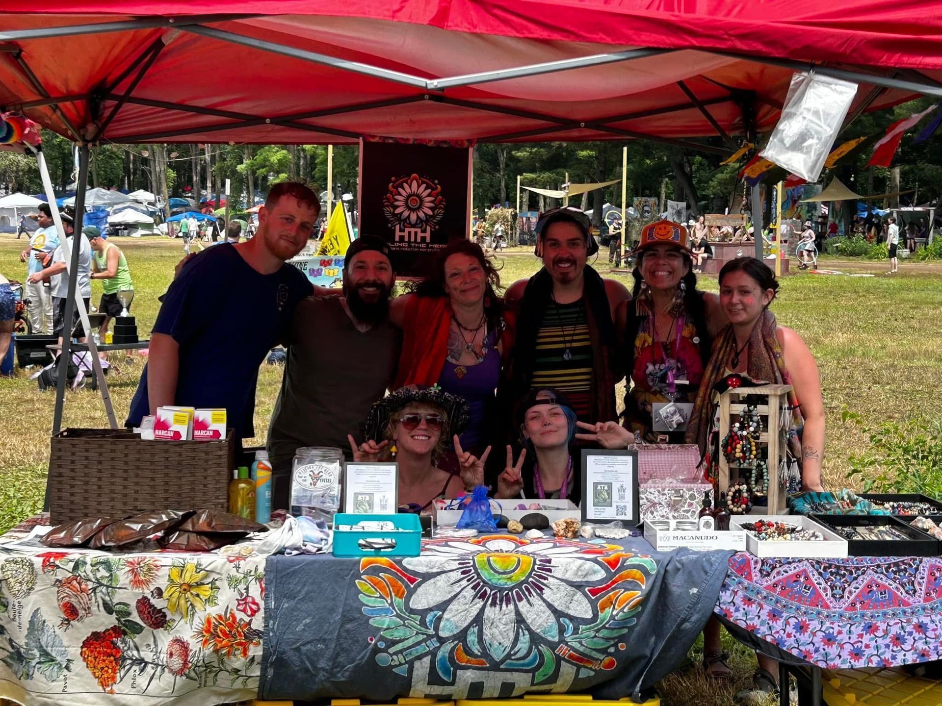 A group of people are posing for a picture under a tent.