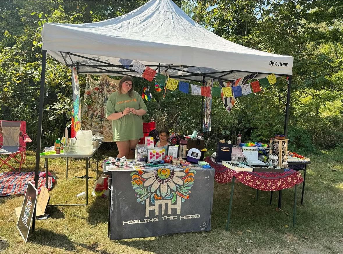 A woman is standing in front of a tent.