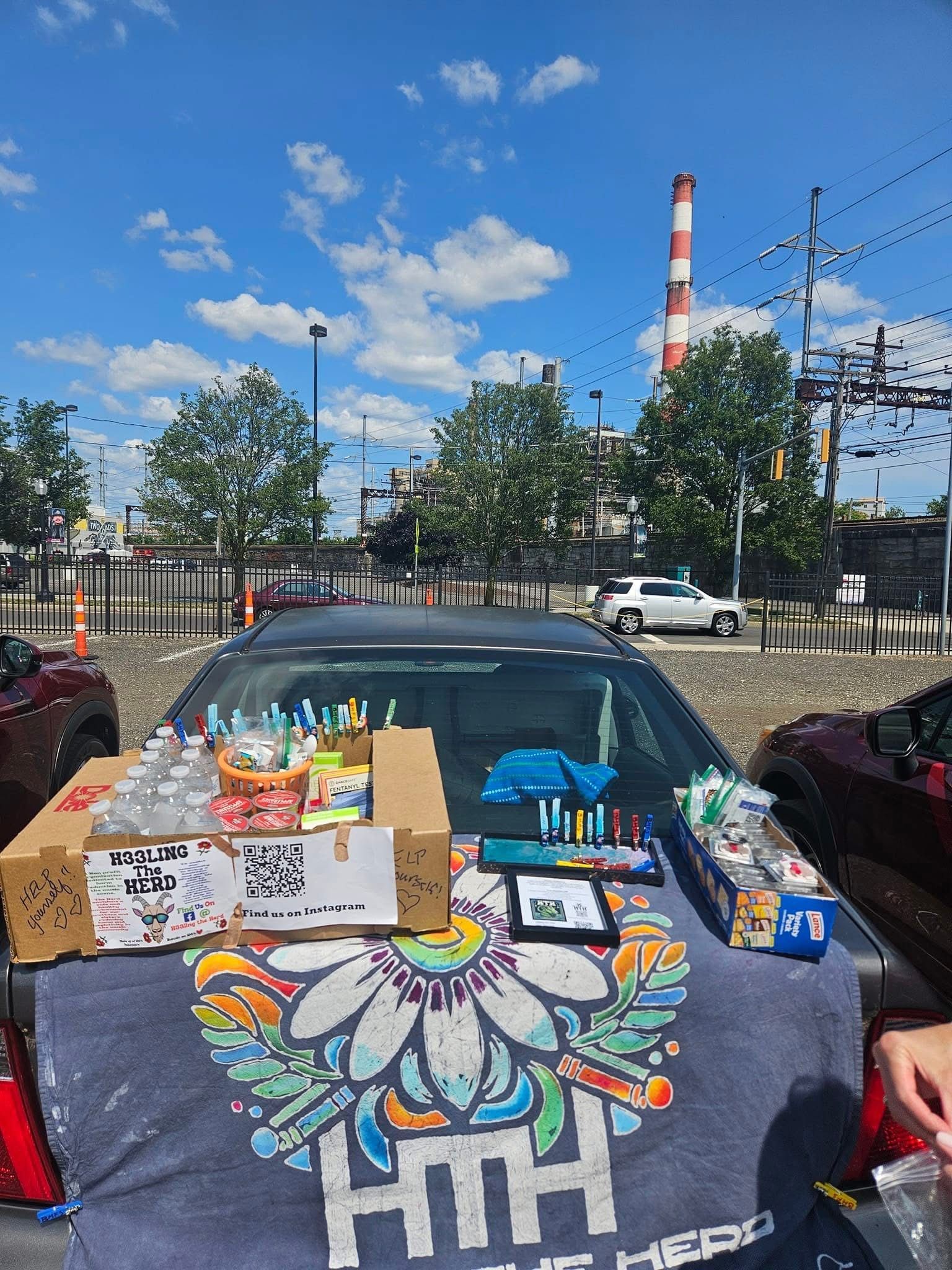 A car is parked in a parking lot with a t-shirt on the back of it.