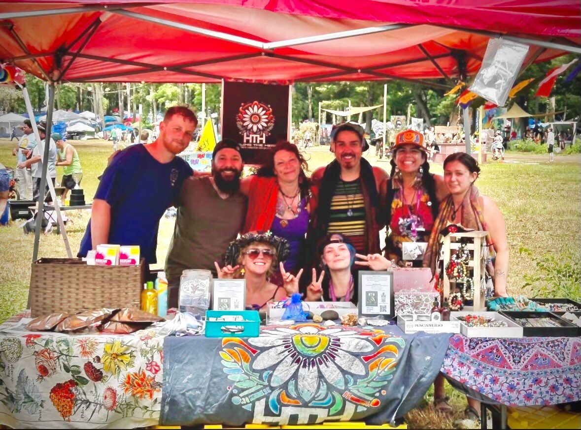 A group of people are posing for a picture in front of a tent.