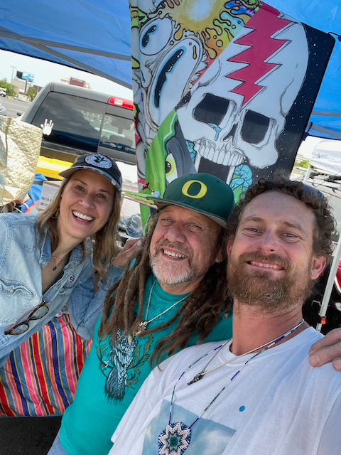 A group of people are posing for a picture under a tent.