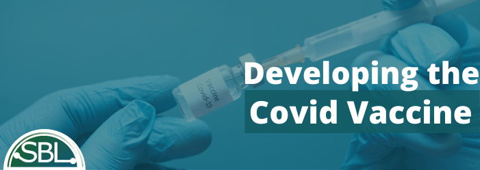 A person is holding a syringe with the words developing the covid vaccine below it