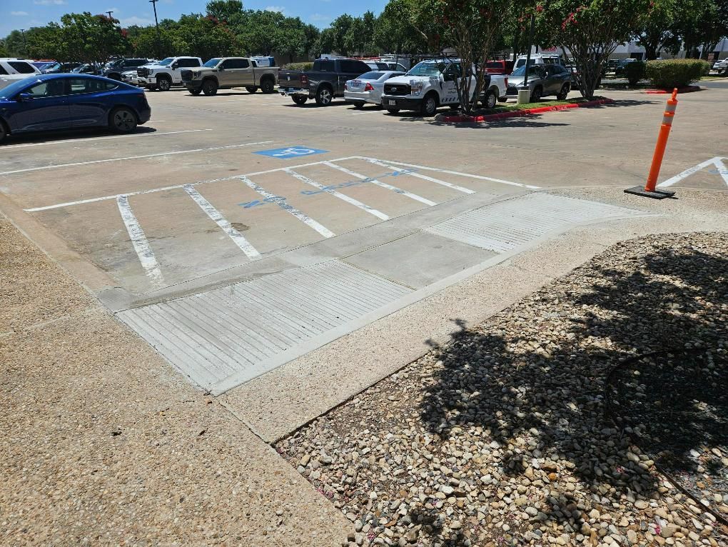 A parking lot with cars parked in it and a handicapped parking spot.