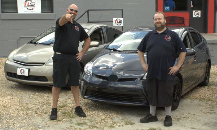 Two men are standing in front of two cars | TLS Motorworks