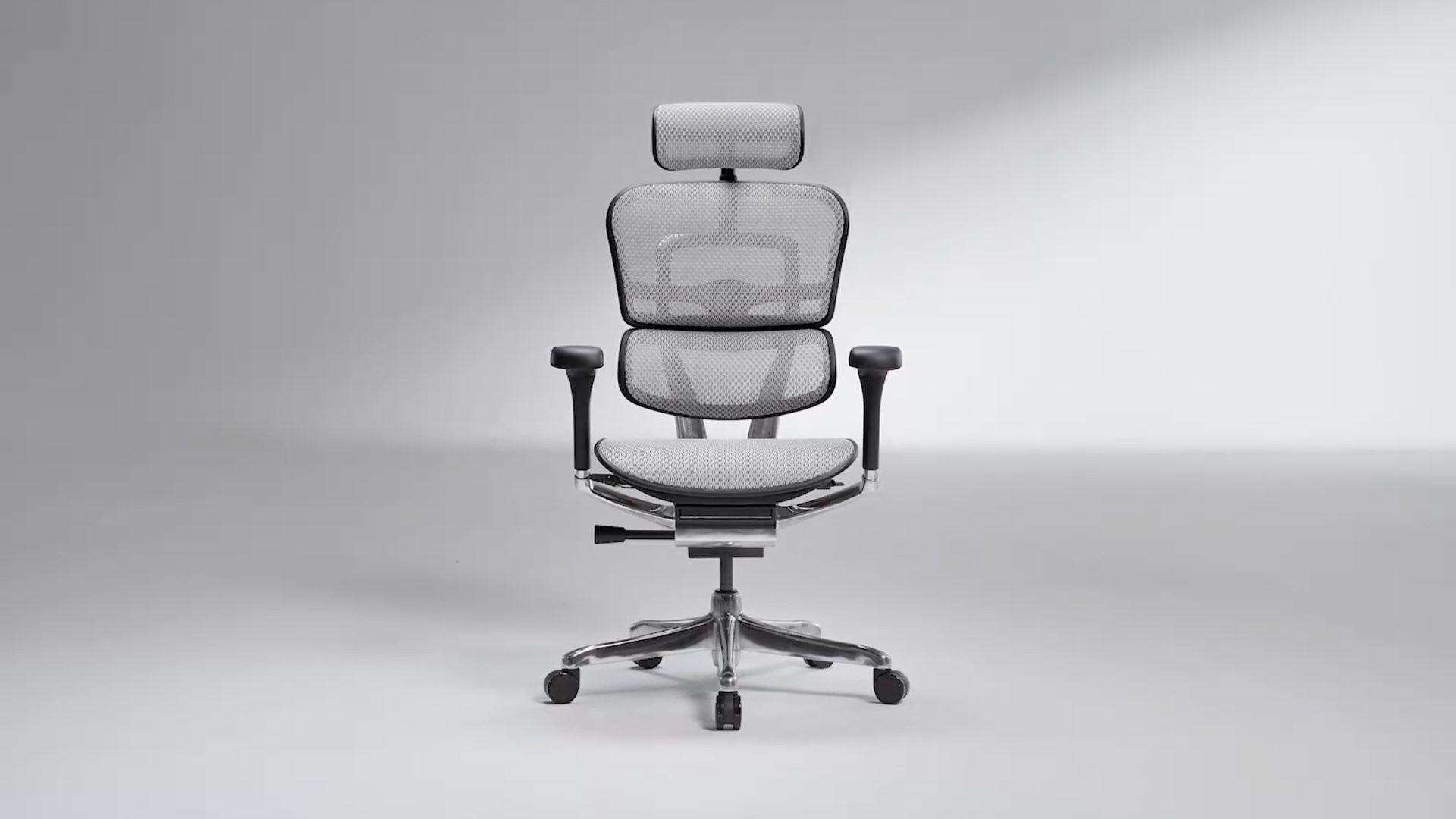 Grey Ergohuman chair in a black frame in an empty light grey room