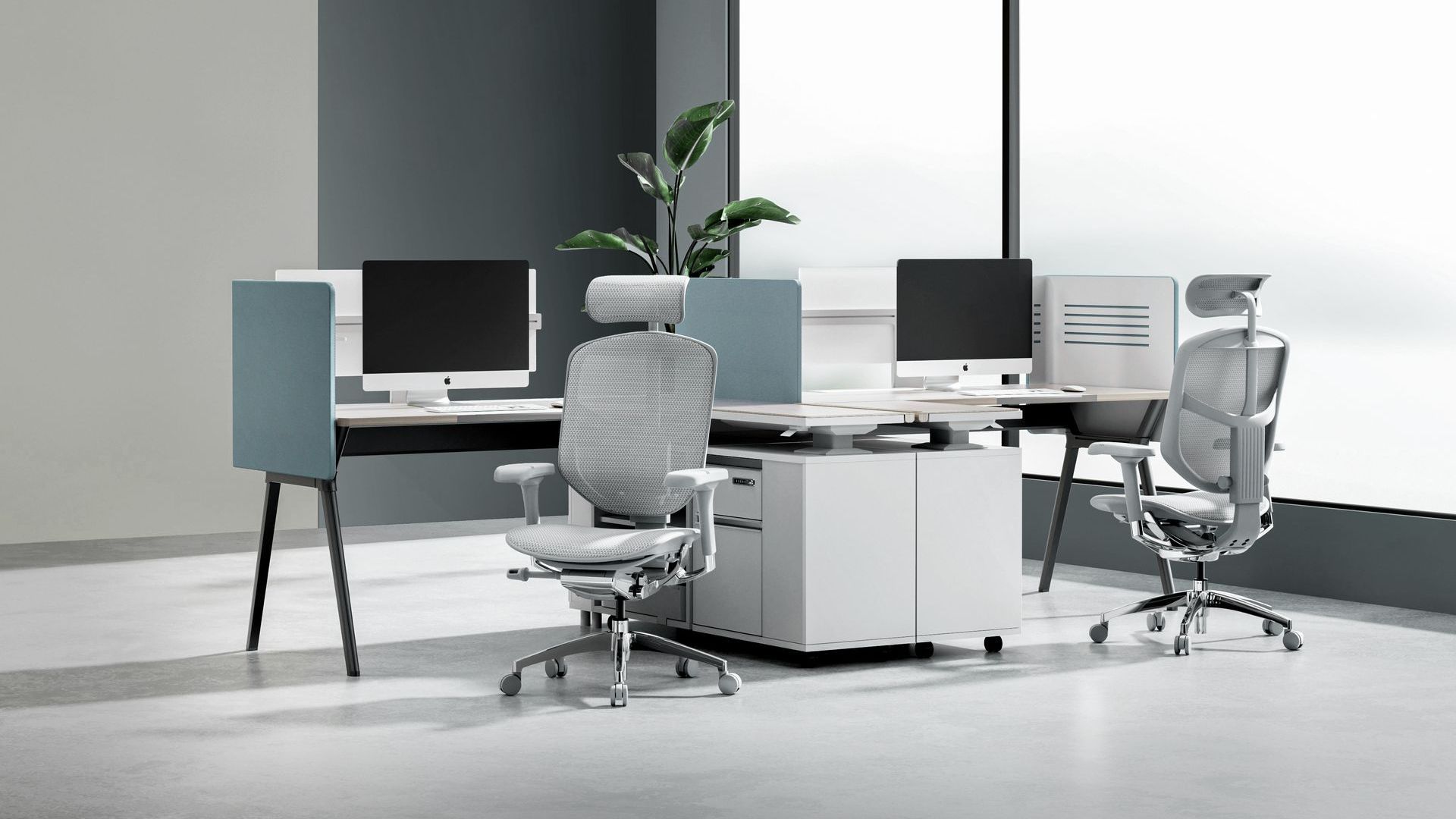 Two grey Enjoy Elite chairs are at two individual desks and booths. 