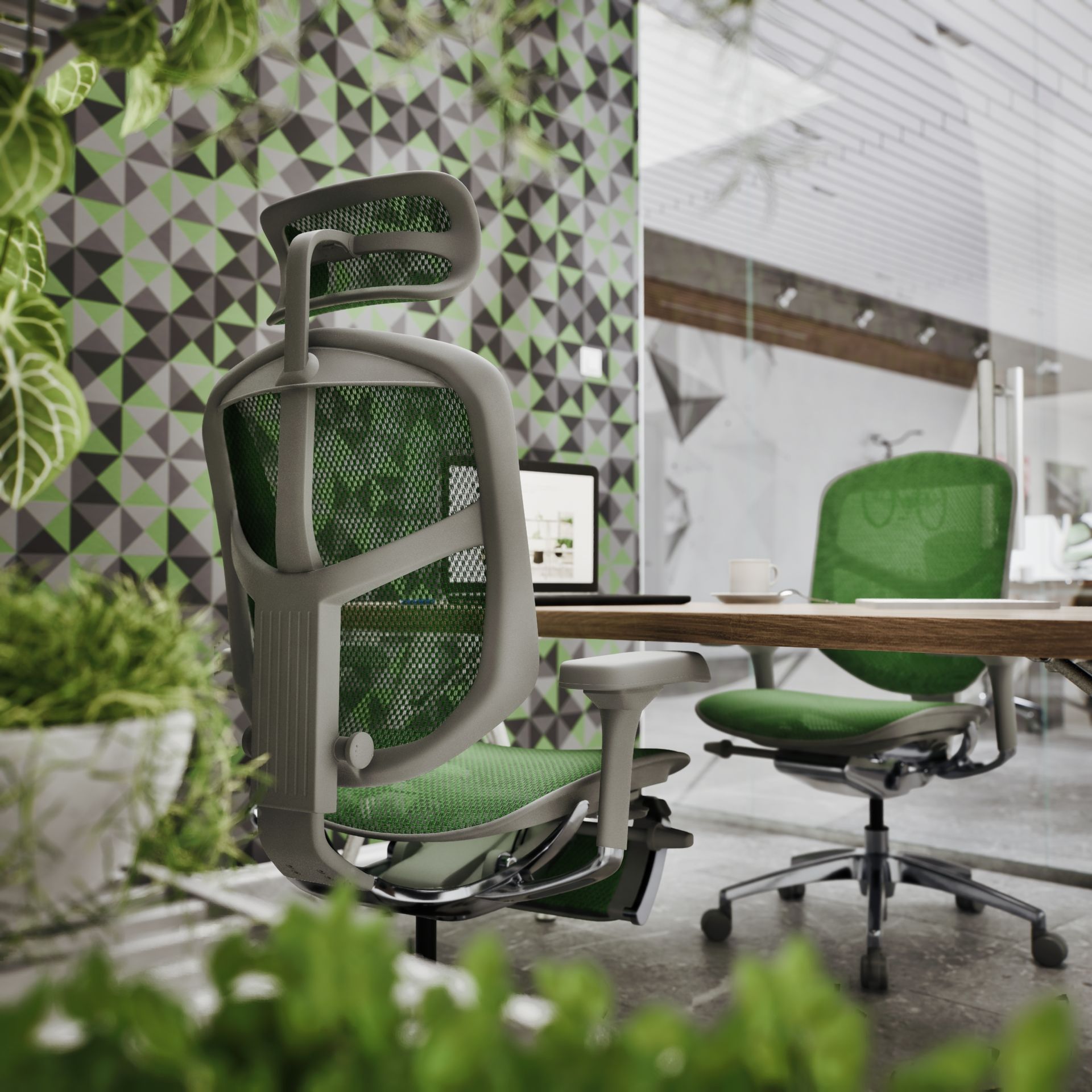 A modern office with two green chairs and trendy wallpaper