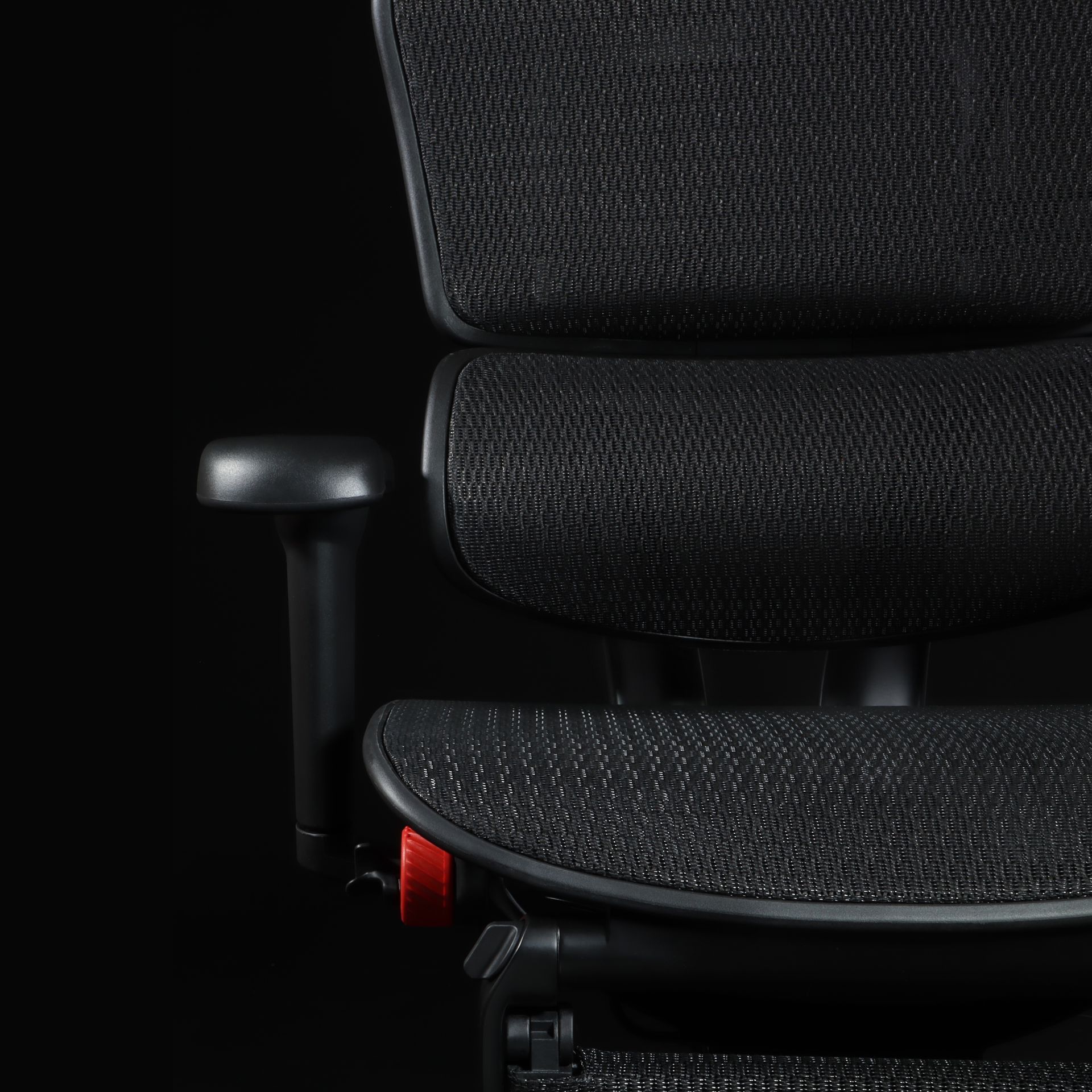 Close up of one half of the Ergohuman Ultra, showing the mesh, back, and armrest