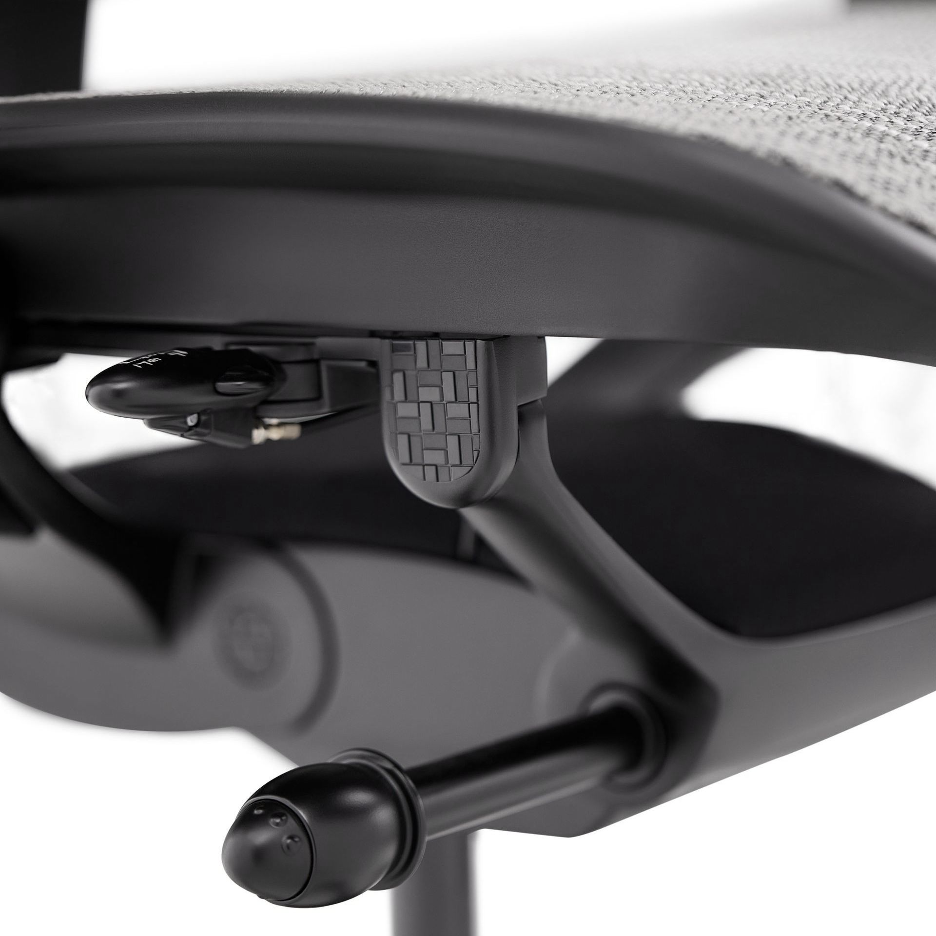 Close up of the synchro-tilt mechanism on the black & grey Ergohuman Carbon
