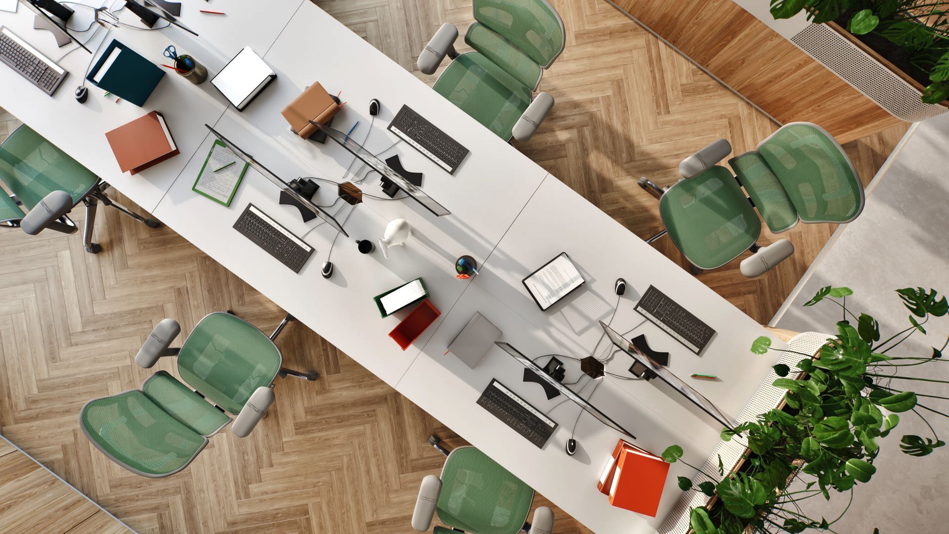 Plan view of Ergohuman Elite ergonomic office chairs in grey frame with green mesh around a white desk table. The floor is herringbone wood. There are planters in the background