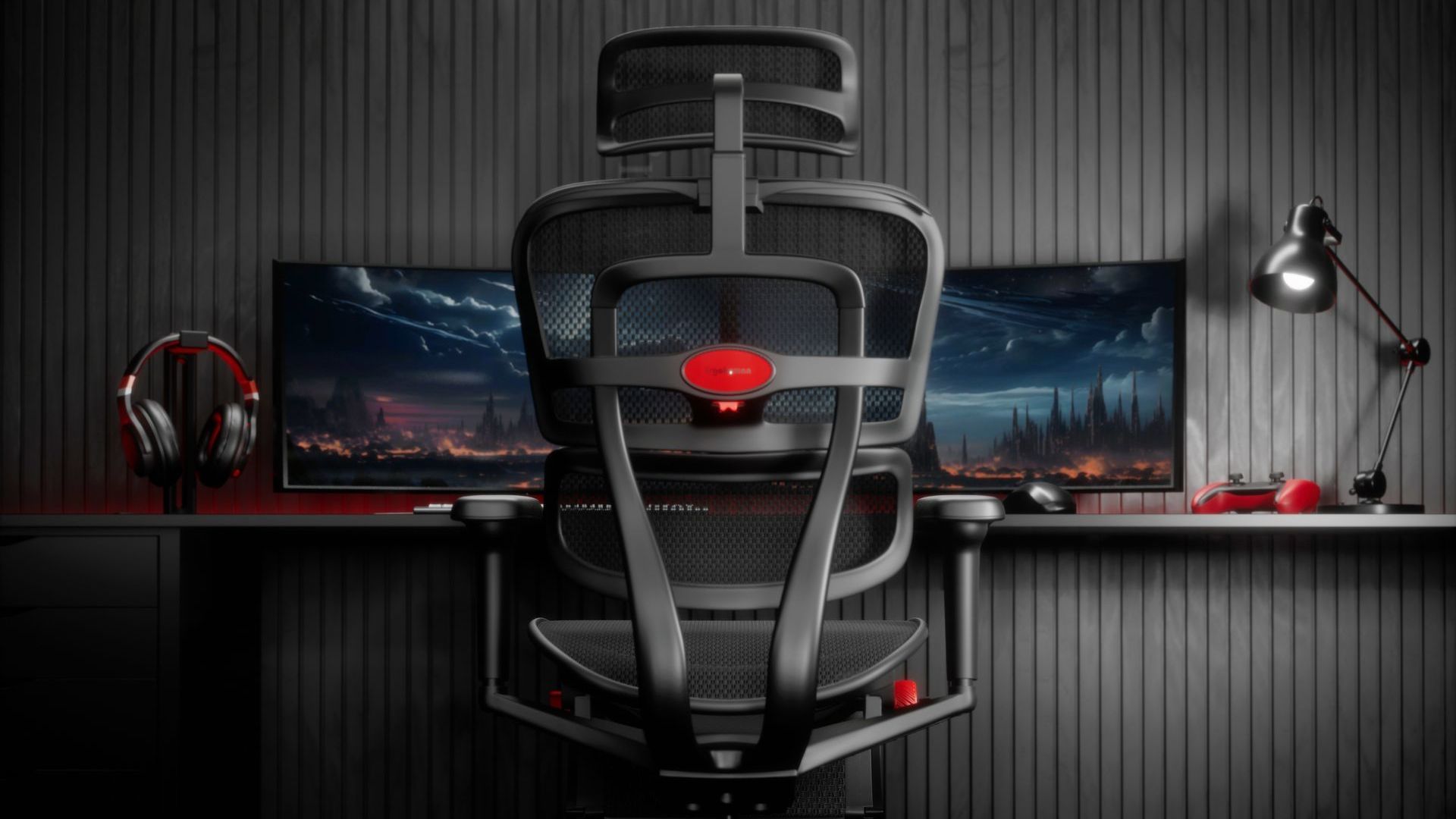 A black Ergohuman Ultra gaming chair sits in front of a desk with dual screens