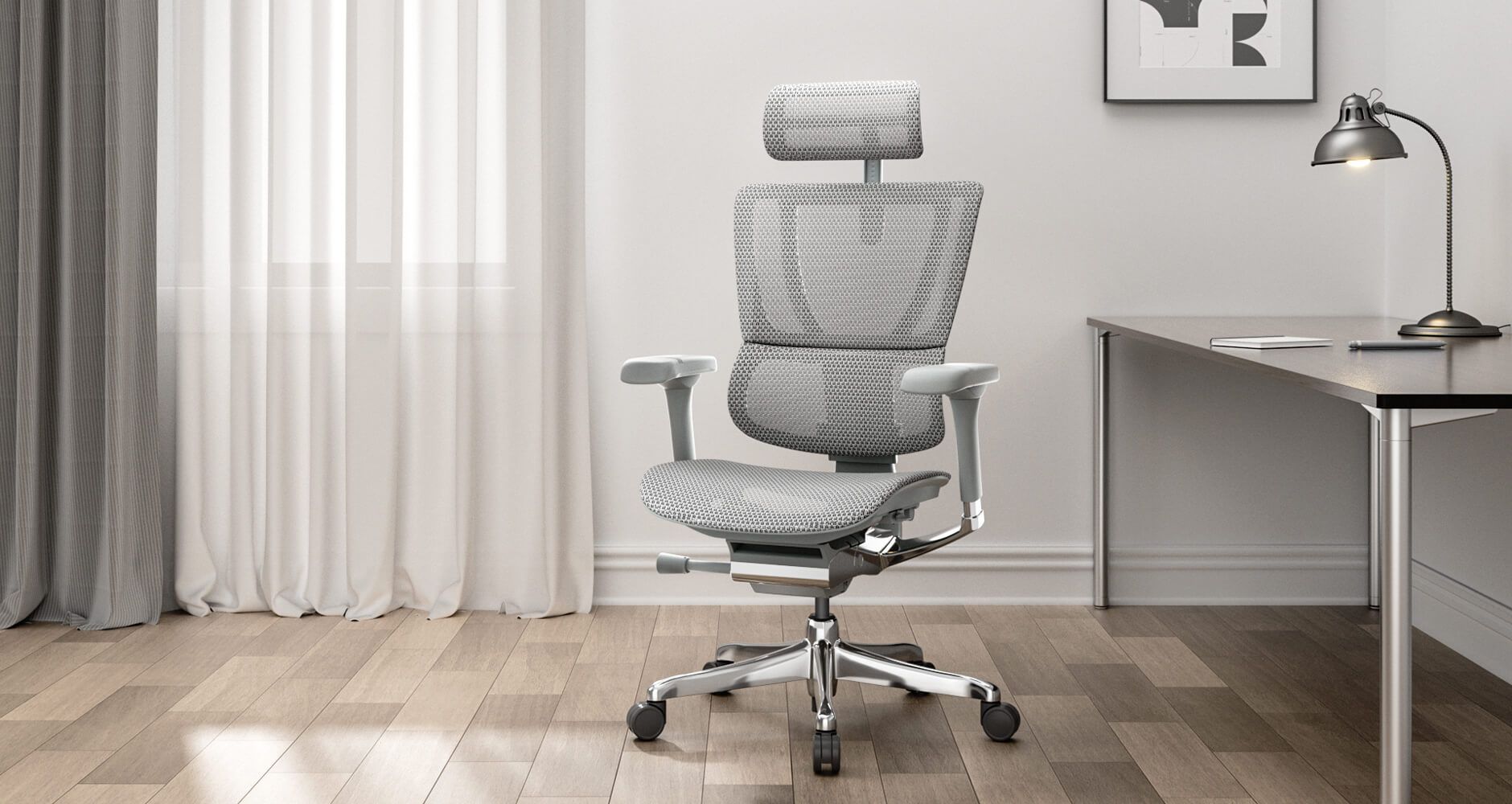 Mirus Elite office chair with silver mesh upholstery at a desk in front of a window.