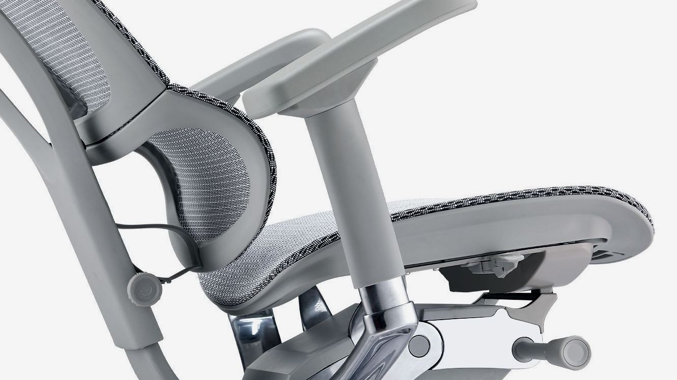 Grey frame Mirus office chair with mesh upholstery, close up of the back corner of the chair, highlighting the tilt back feature