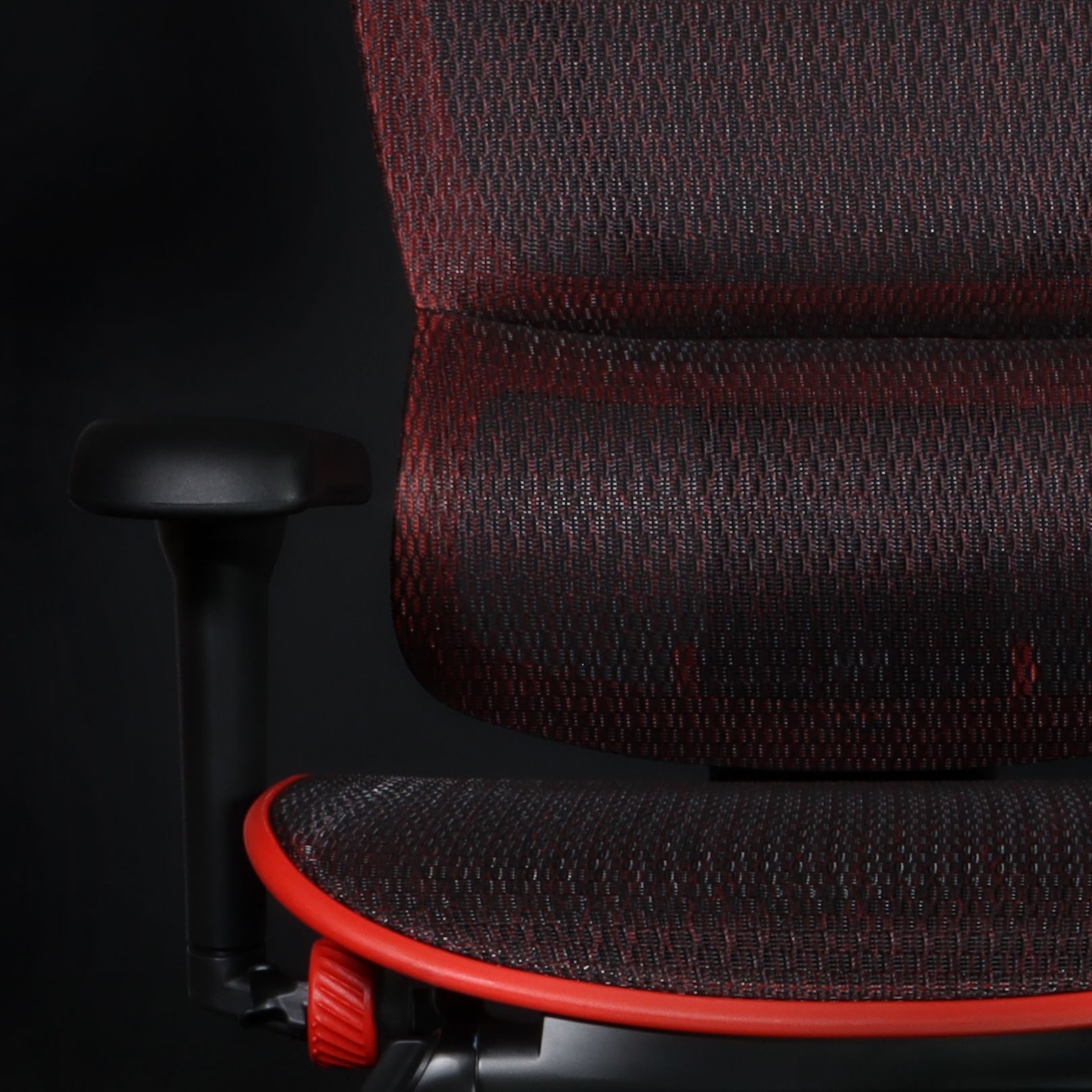 Close up of one half of the Mirus Ultra, showing the mesh, back, and armrest