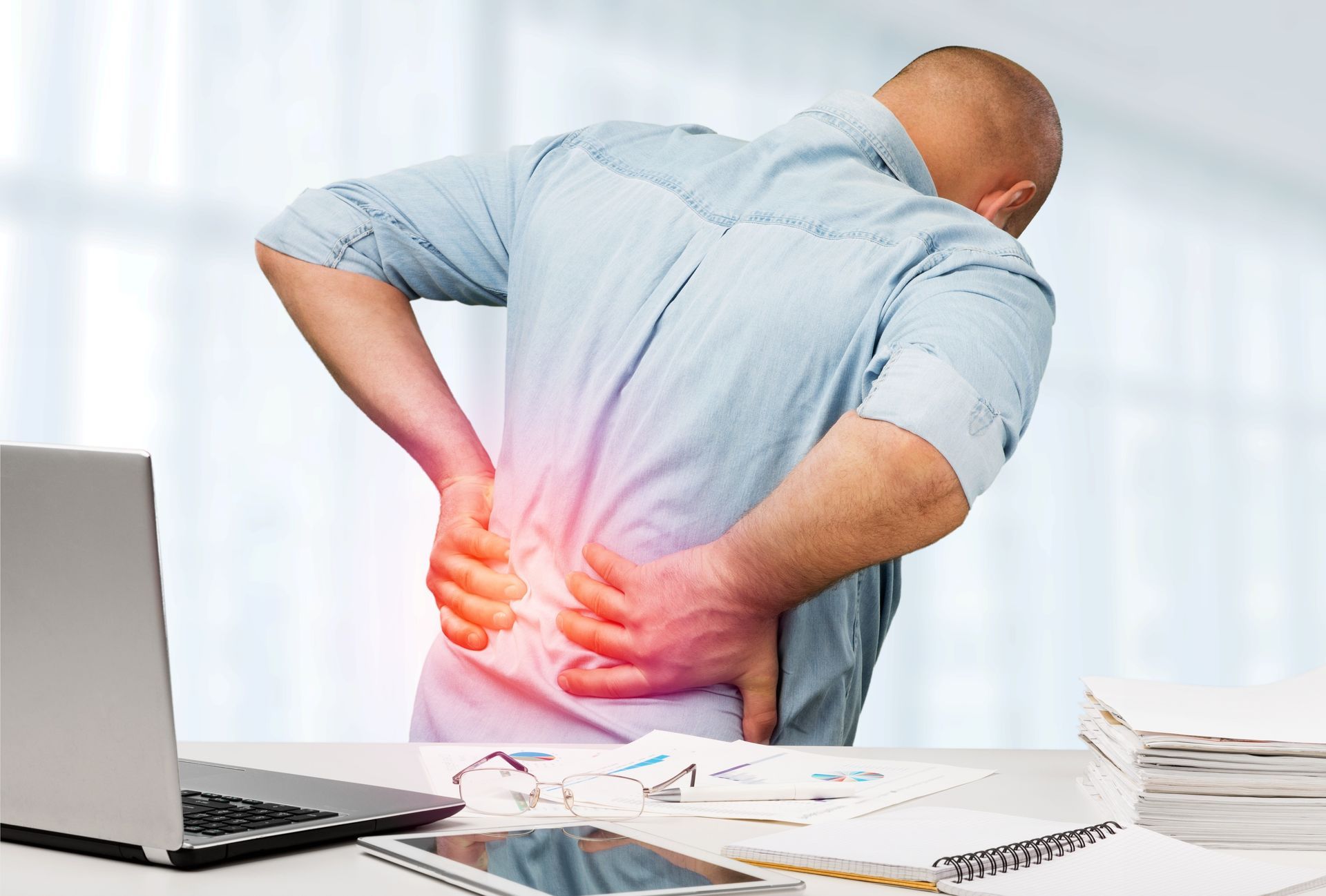 Man in office with back pain 