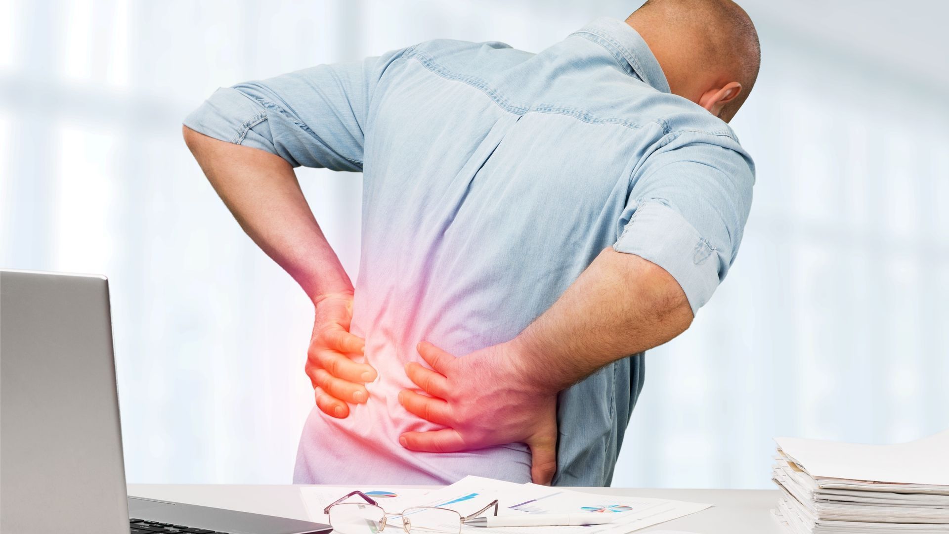 Man in an office suffering from back pain