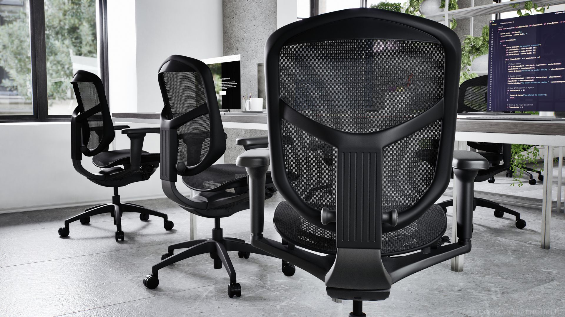 Black mesh office chairs sit at a row of desks in a modern office