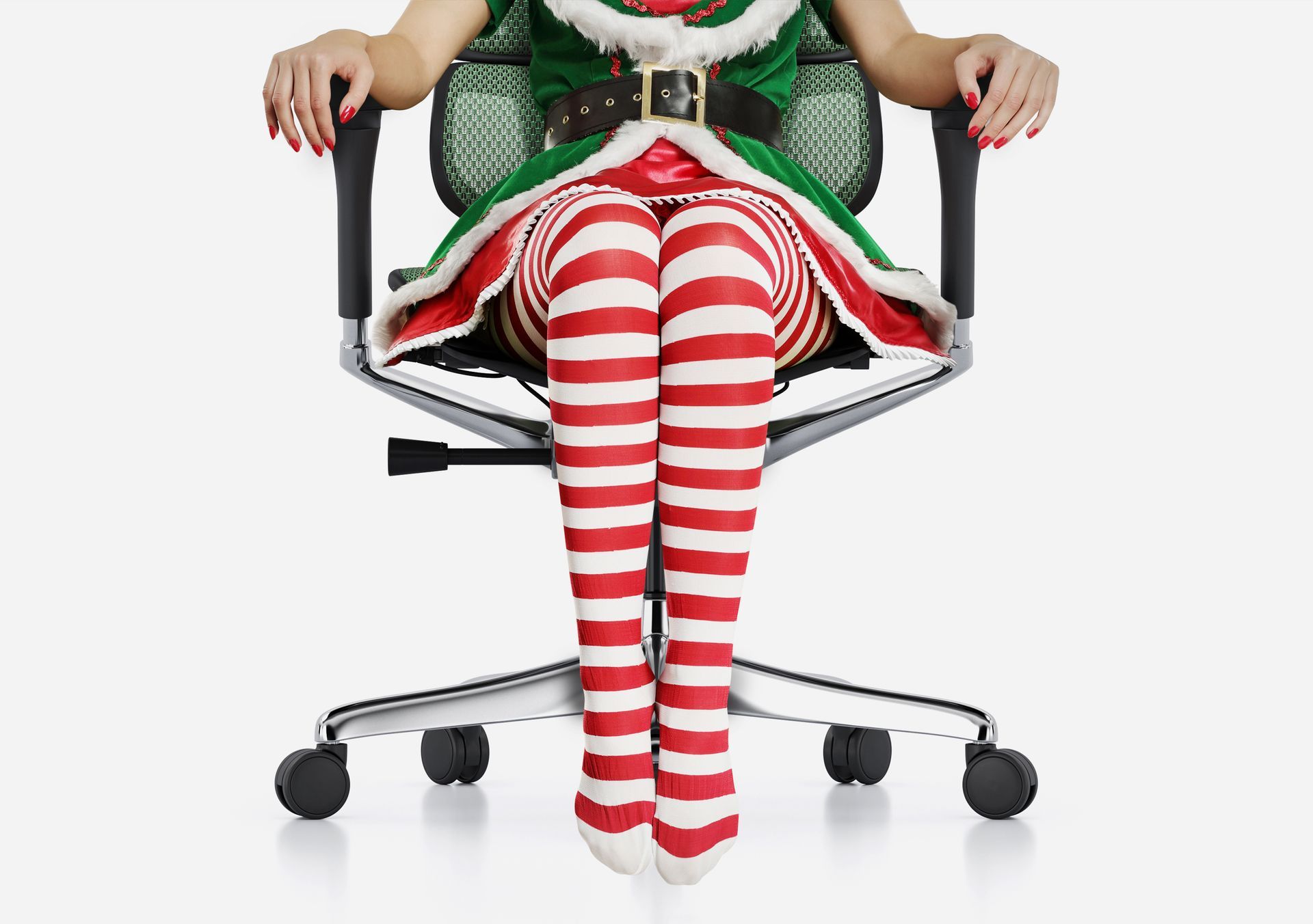 a lady wearing candy cane tights and a green elf-style dress sitting in a comfort ergohuman chair